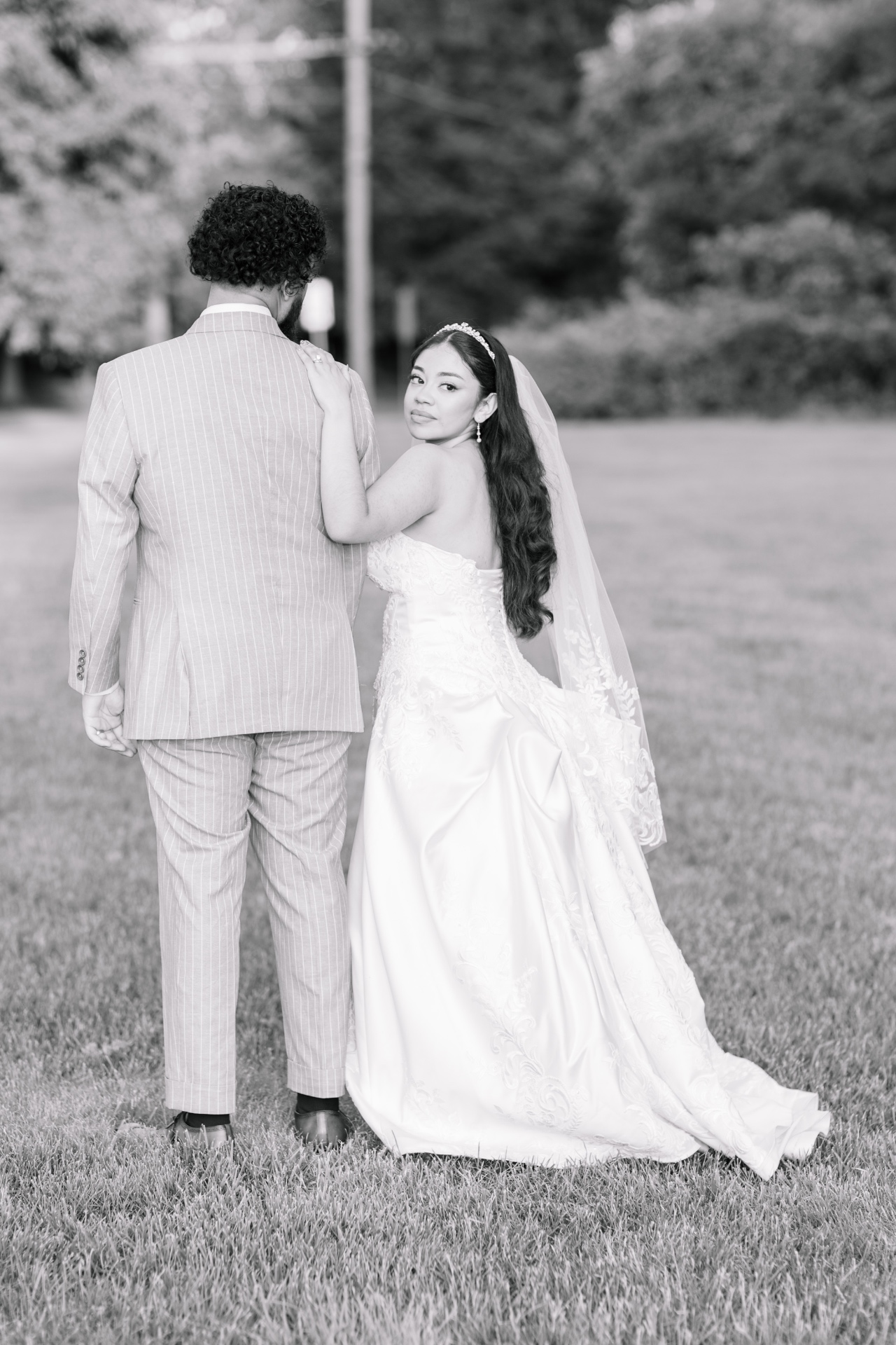 Bride looking back with groom, black and white